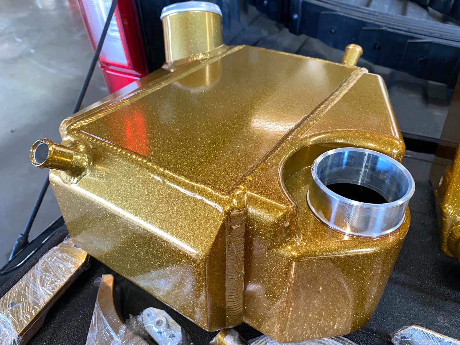 A gold tank is sitting on top of a table.