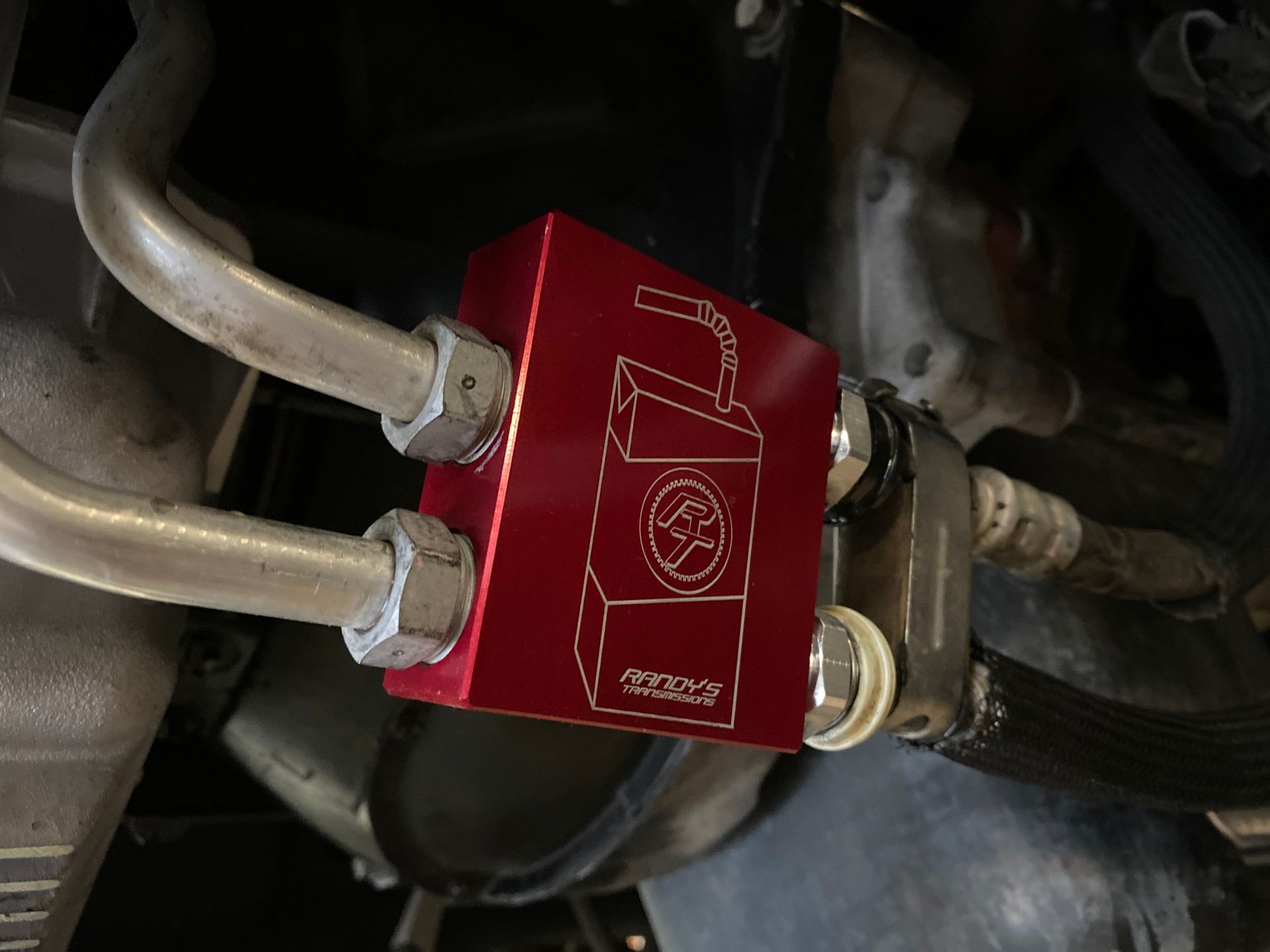 A close up of a red box with hose attached to it.