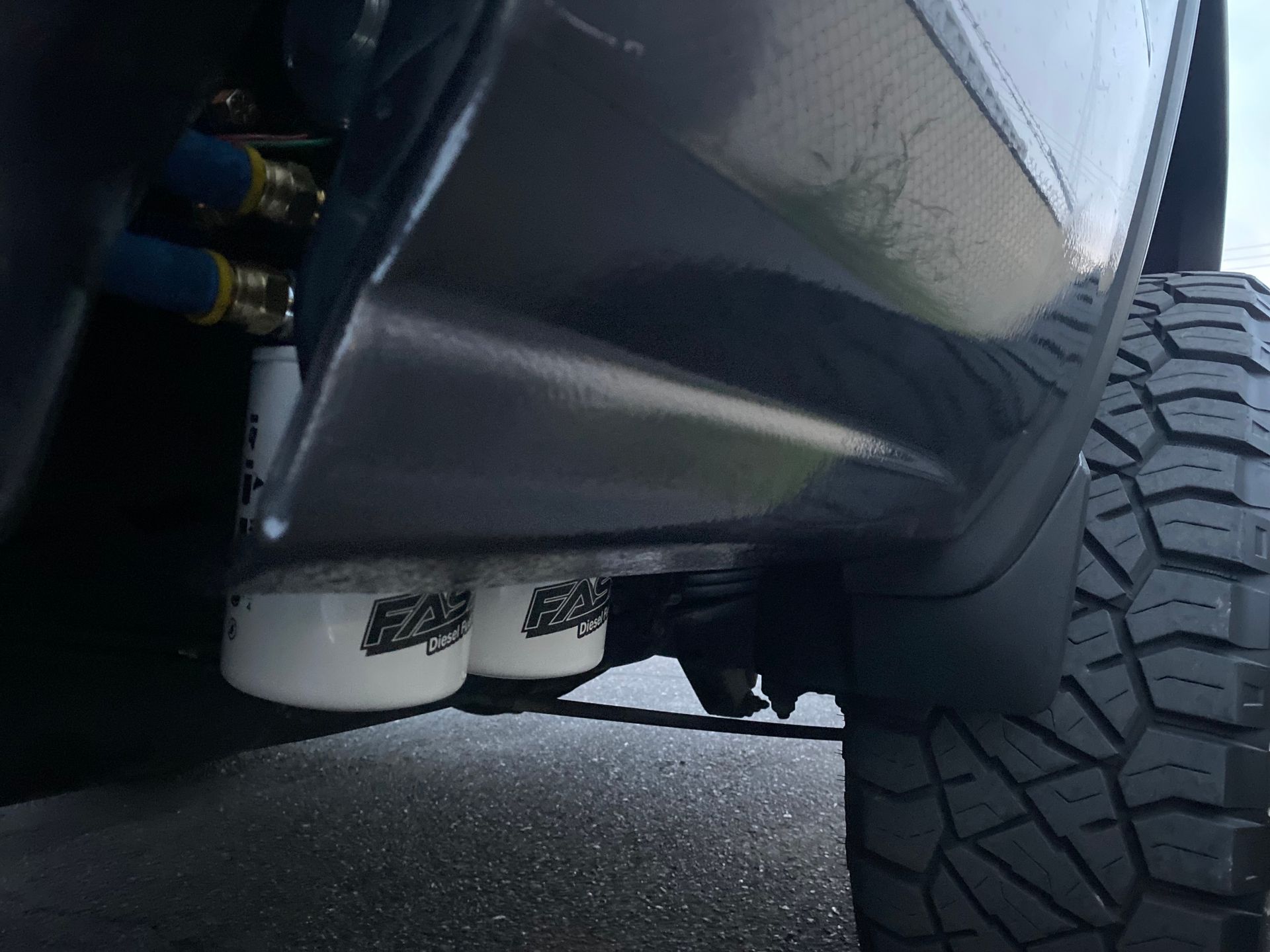 A close up of the underside of a truck with a fuel filter