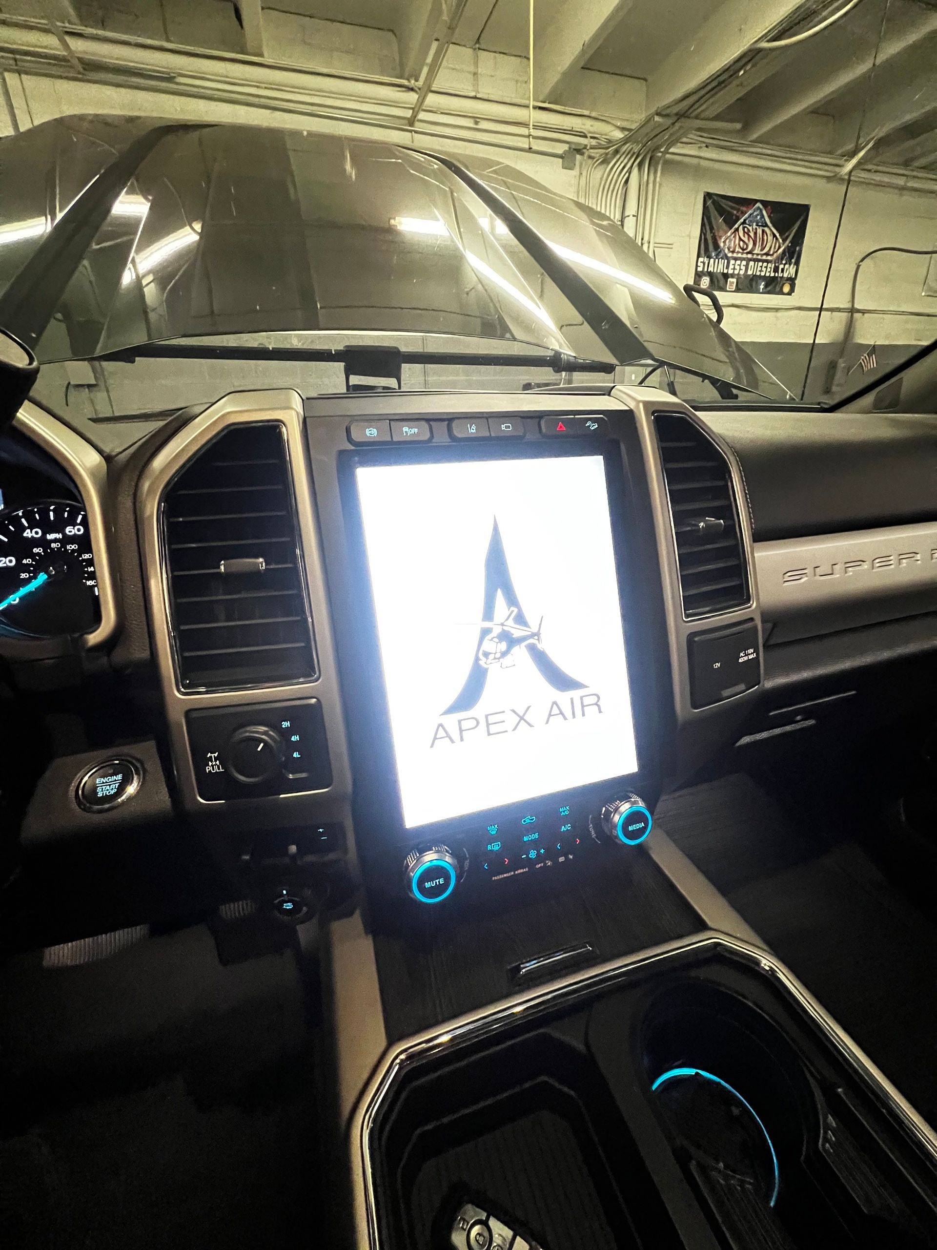 The inside of a car with a large screen on the dashboard.