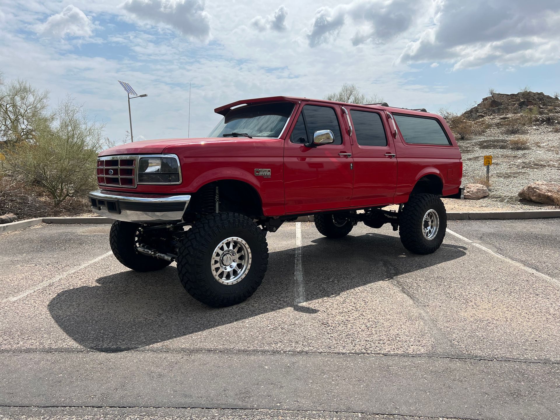 A red suv is parked in a parking lot.