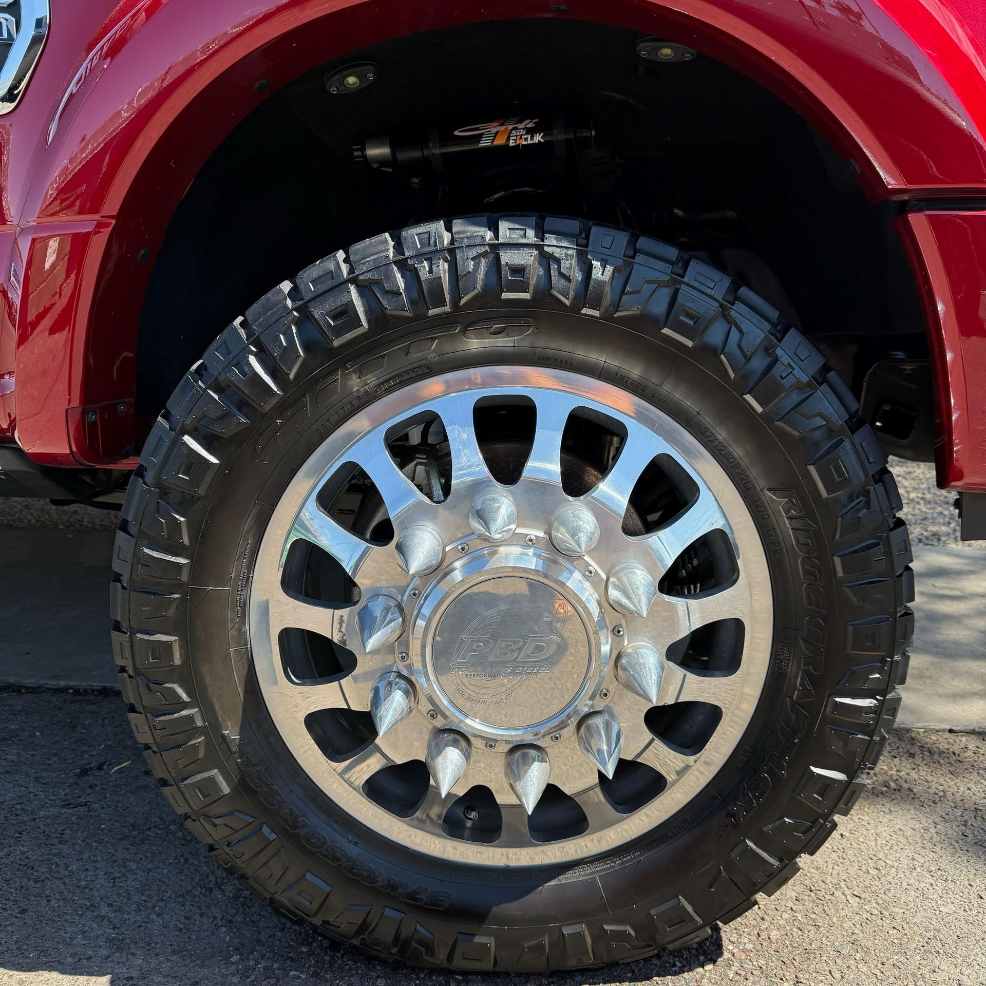 A close up of a tire on a red truck