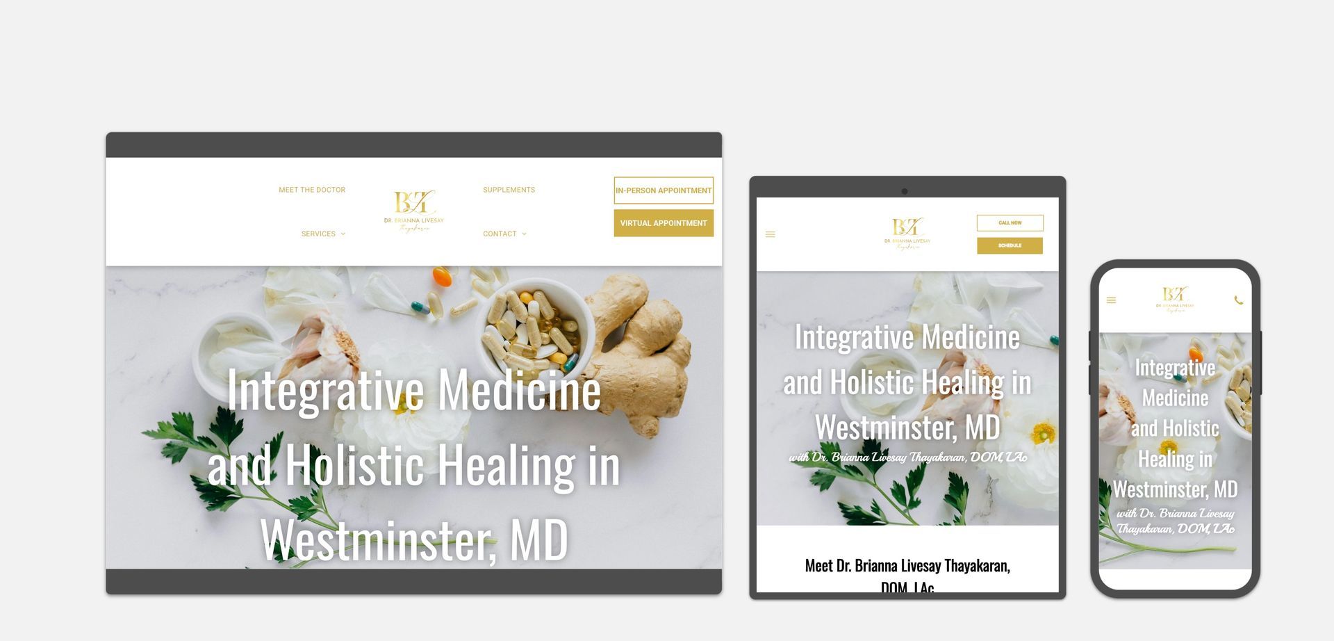 A website for integrative medicine and holistic healing is displayed on a tablet and a cell phone.