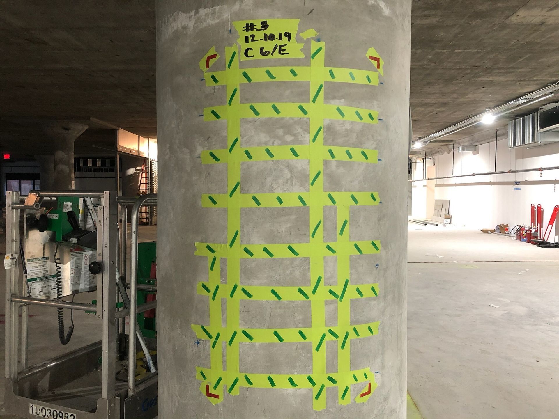 A man is standing in front of a bulldozer on a construction site.
