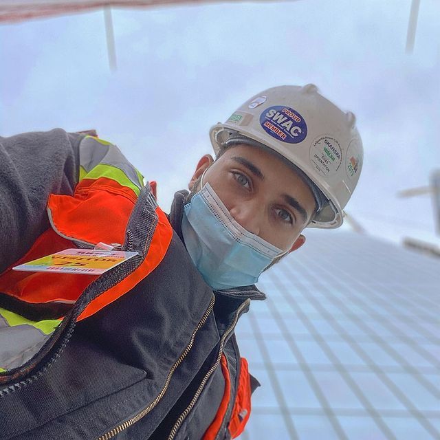 A man wearing a hard hat with the word swac on it