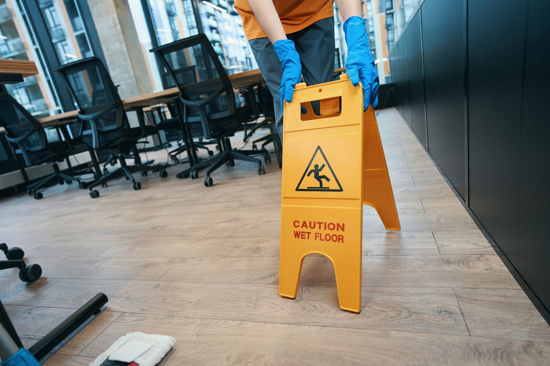 Person in blue gloves placing a yellow