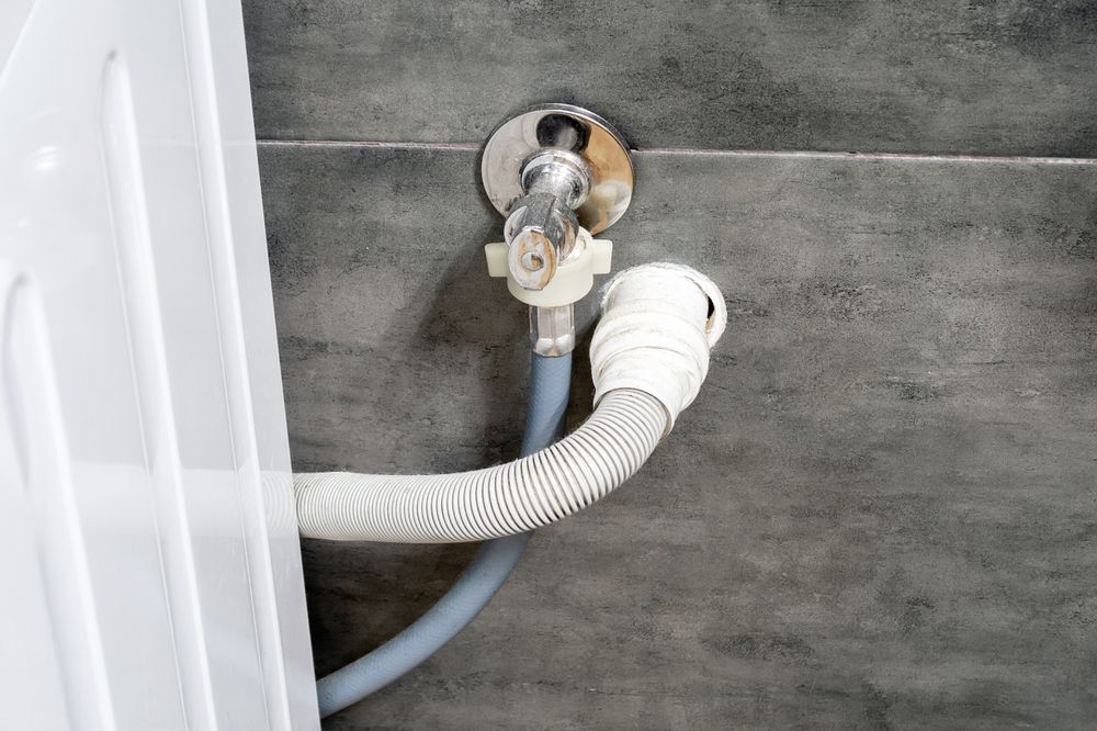 Drain Hose Connected to a Wall Pipe Near an Appliance — RAW Plumbing & Gasfitting in Tuggeranong, ACT