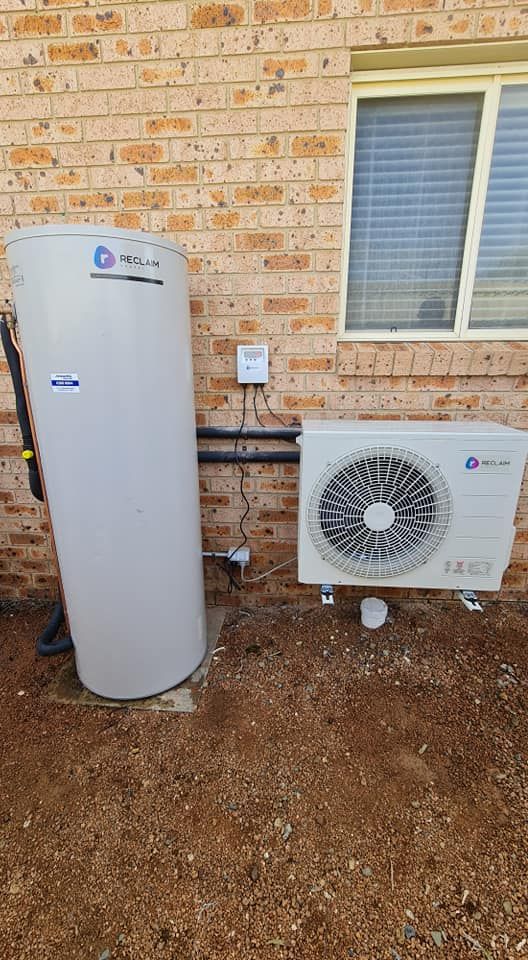 A Water Heater And Air Conditioner Are Installed On A Building —  RAW Plumbing & Gasfitting In Pearce, ACT