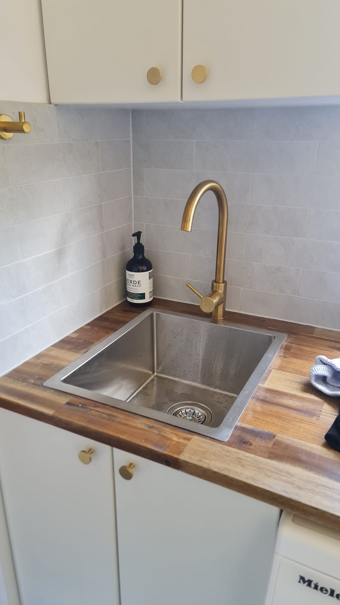 A Kitchen Sink With A Brass Faucet On A Wooden Counter Top —  RAW Plumbing & Gasfitting In Pearce, ACT