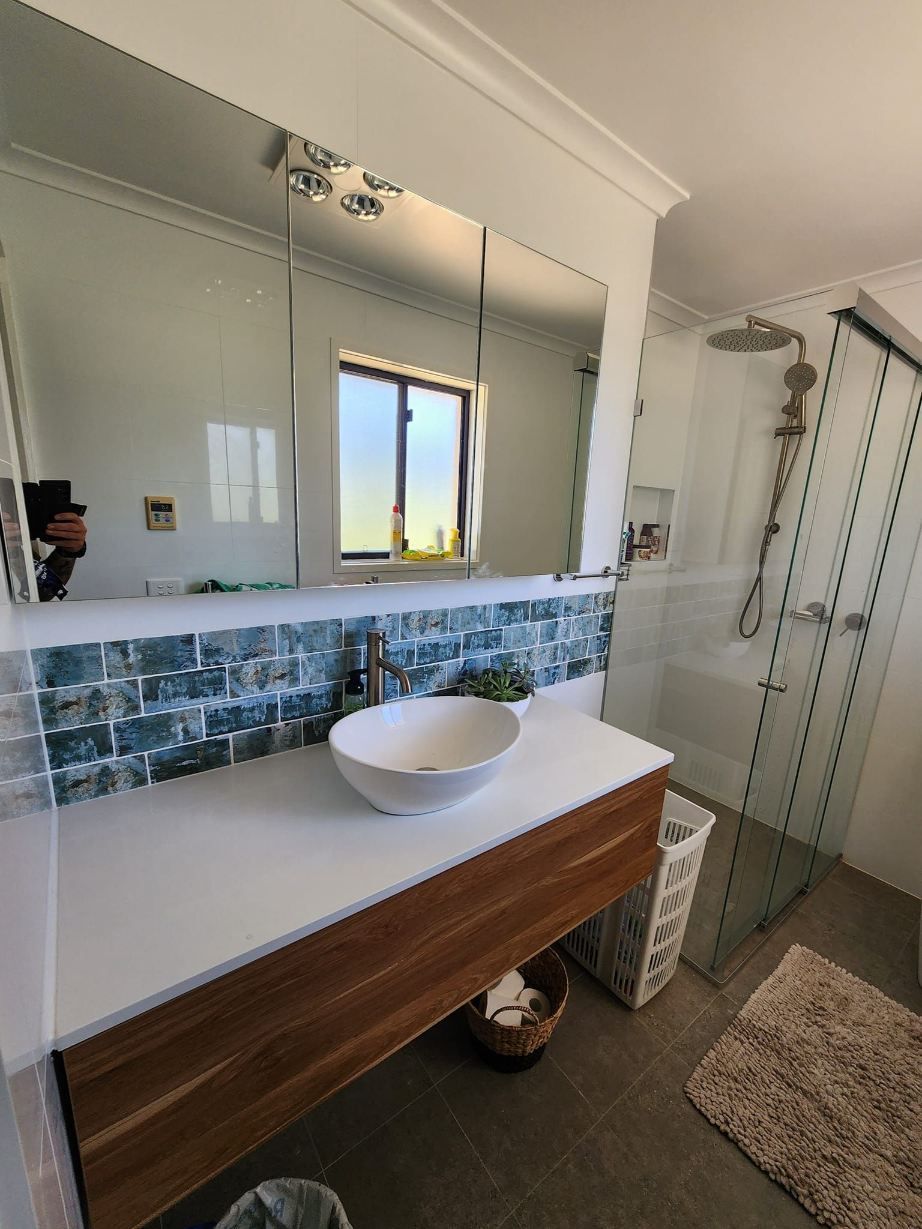 A Bathroom With A Sink , Mirror And Shower —  RAW Plumbing & Gasfitting In Pearce, ACT