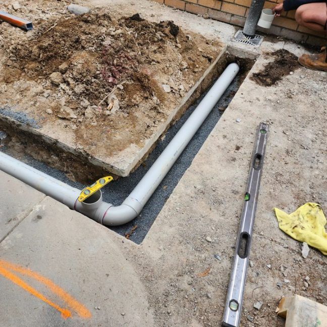 A Drain Pipe Is Being Installed In A Hole In The Ground —  RAW Plumbing & Gasfitting In Pearce, ACT