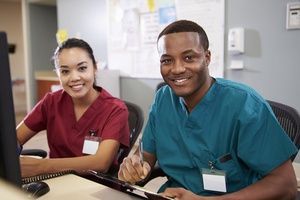 A doctor is holding a tablet in his hands.