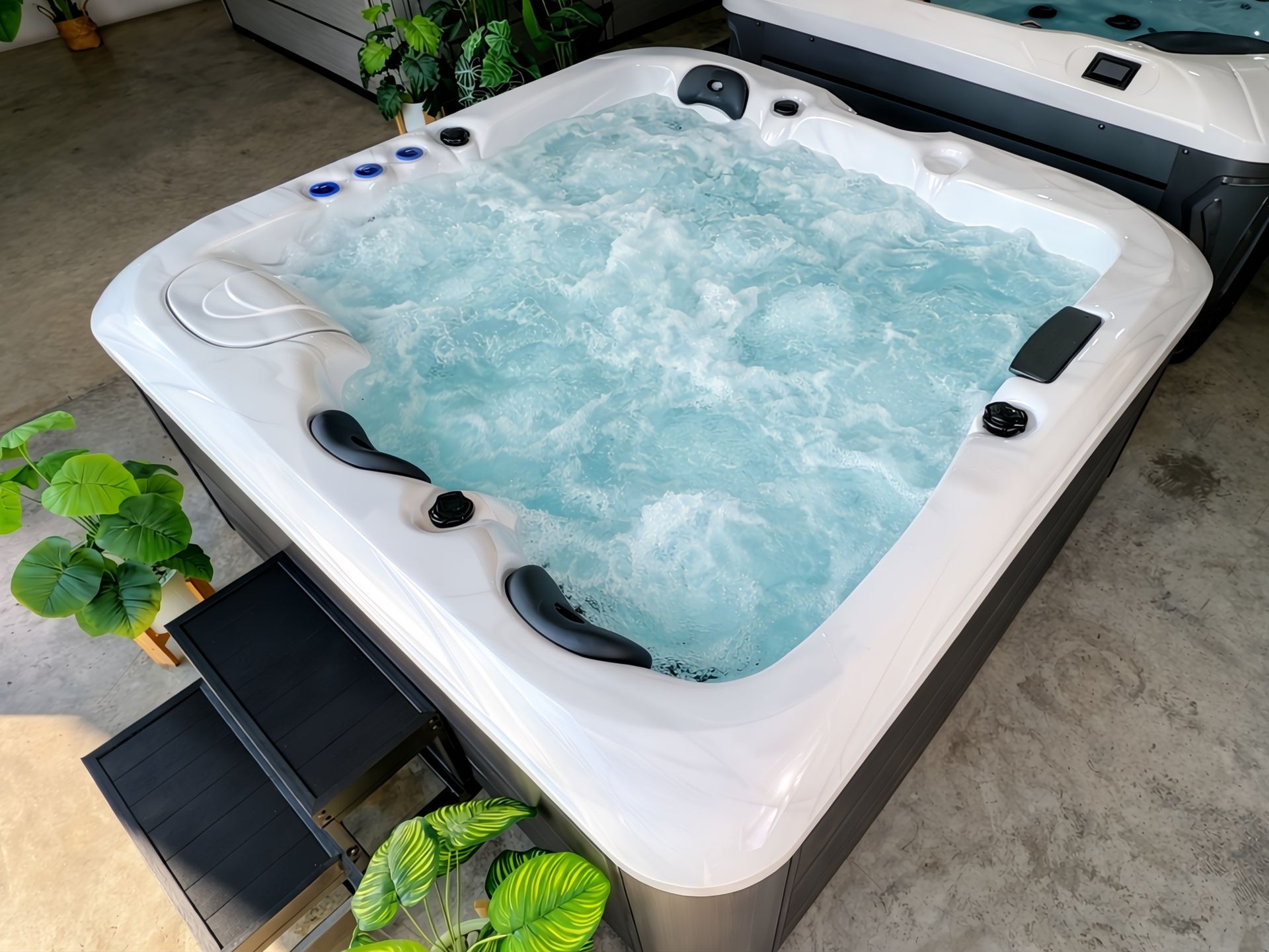 Modern 4-person outdoor hot tub with white acrylic shell and powerful hydrotherapy jet system, featuring bubbling water massage, ideal for luxury homes, villas, and resorts in Thailand