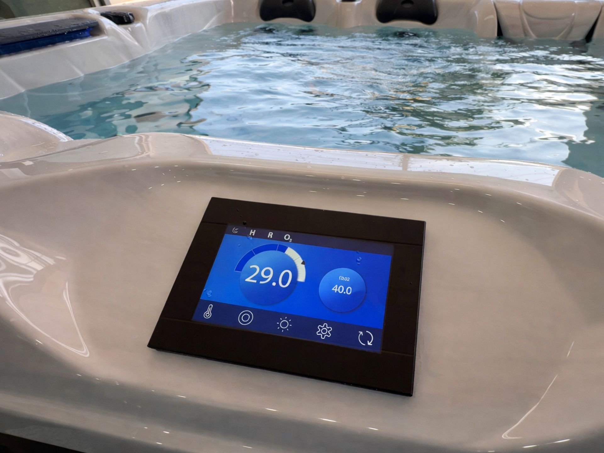 Image of a digital touchscreen control panel on an outdoor hot tub, displaying water temperature settings at 29°C. The built-in heater system allows temperature adjustment up to 40°C with automatic heat retention, ensuring warm water is ready 24 hours a day, ideal for residential homes, luxury villas, and resort spa installations in Thailand.