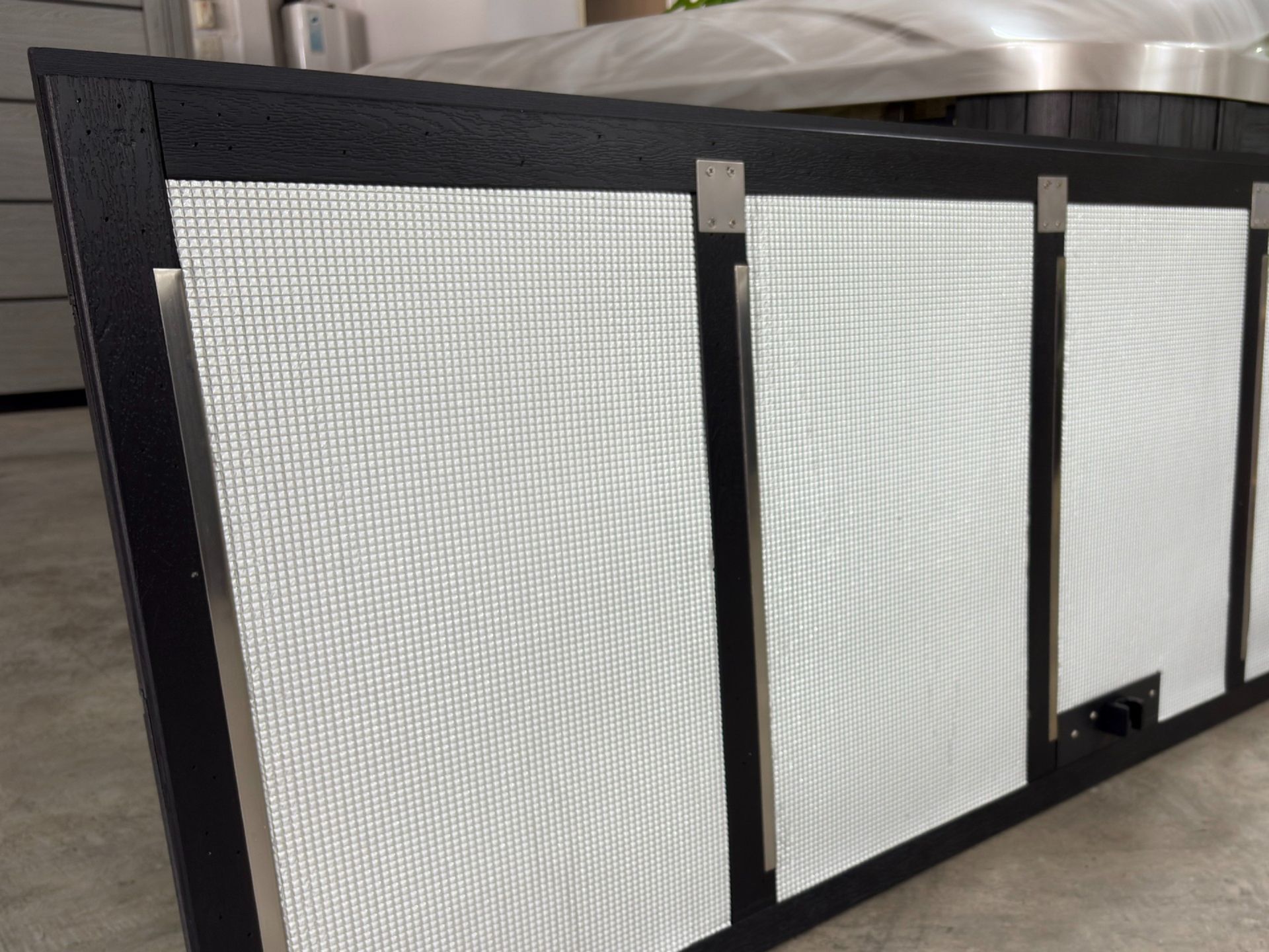 Foil-backed foam insulation installed behind hot tub cabinet panels for heat retention