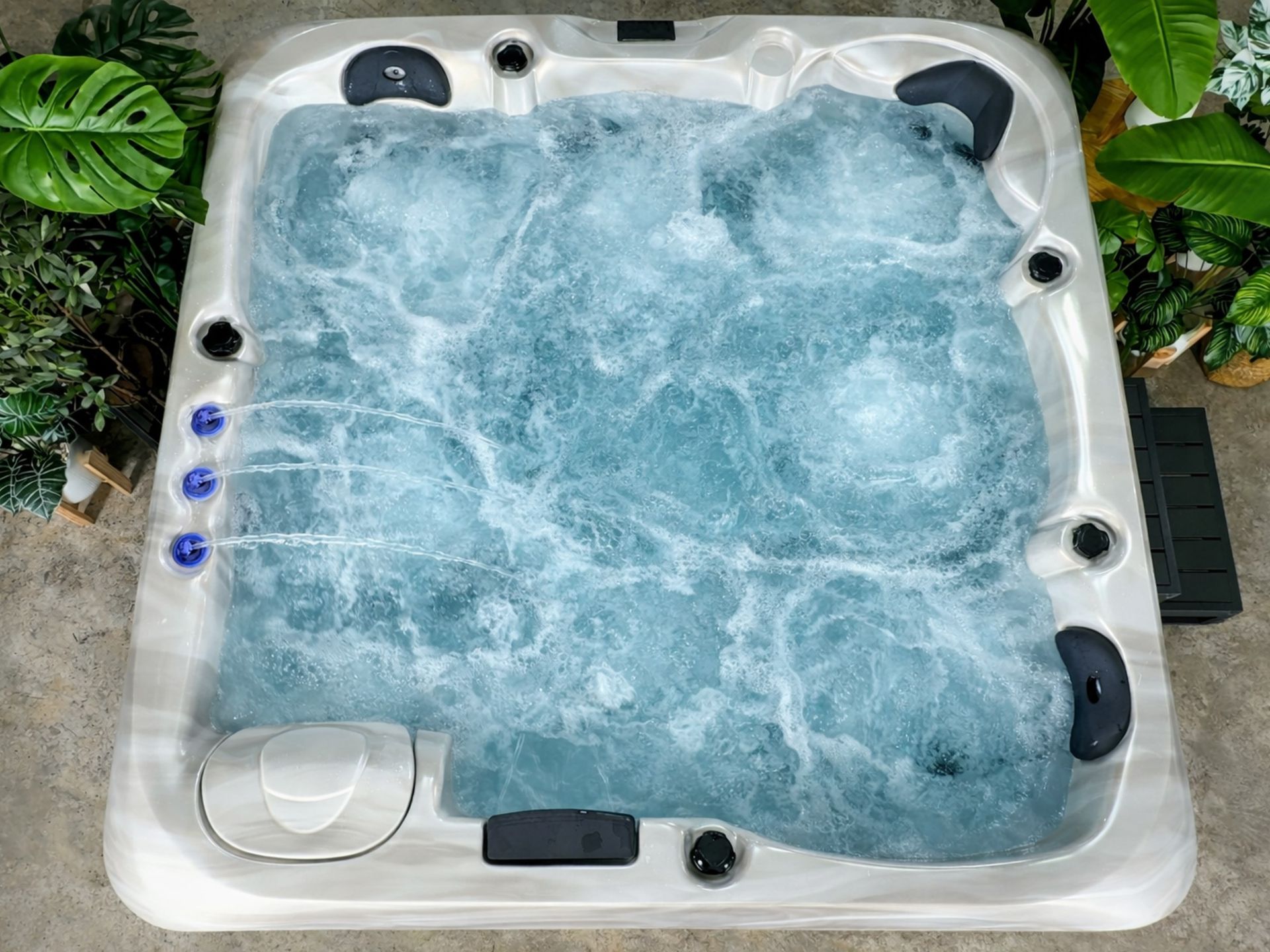 Top view of MARINA 5-person outdoor hot tub with powerful hydrotherapy jet system in action, creating full water circulation for muscle relaxation and home spa therapy.