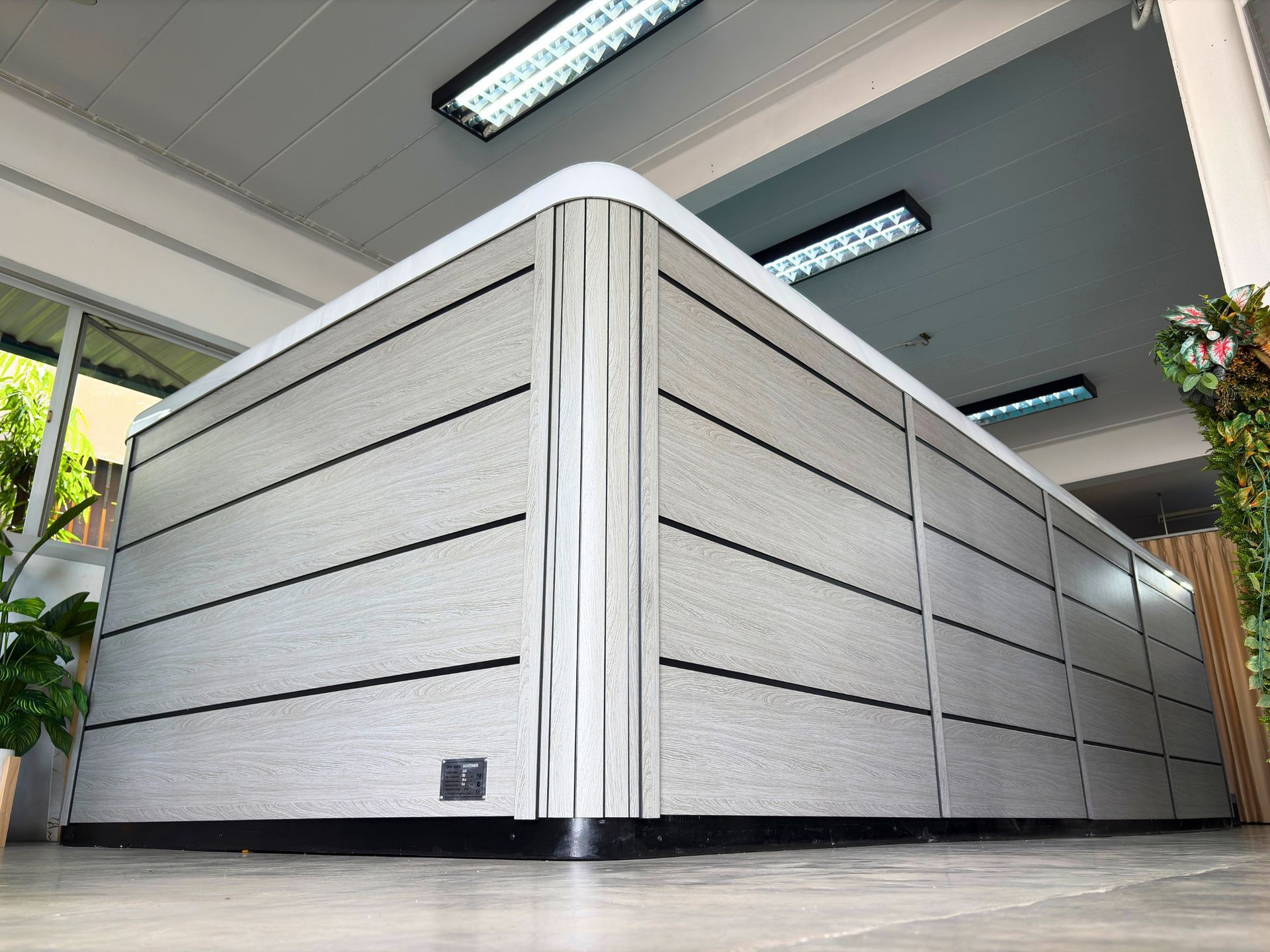 Modern above-ground swim spa with wood-look composite cabinet, durable weather-resistant design, compact size suitable for Thai homes and indoor or outdoor installation