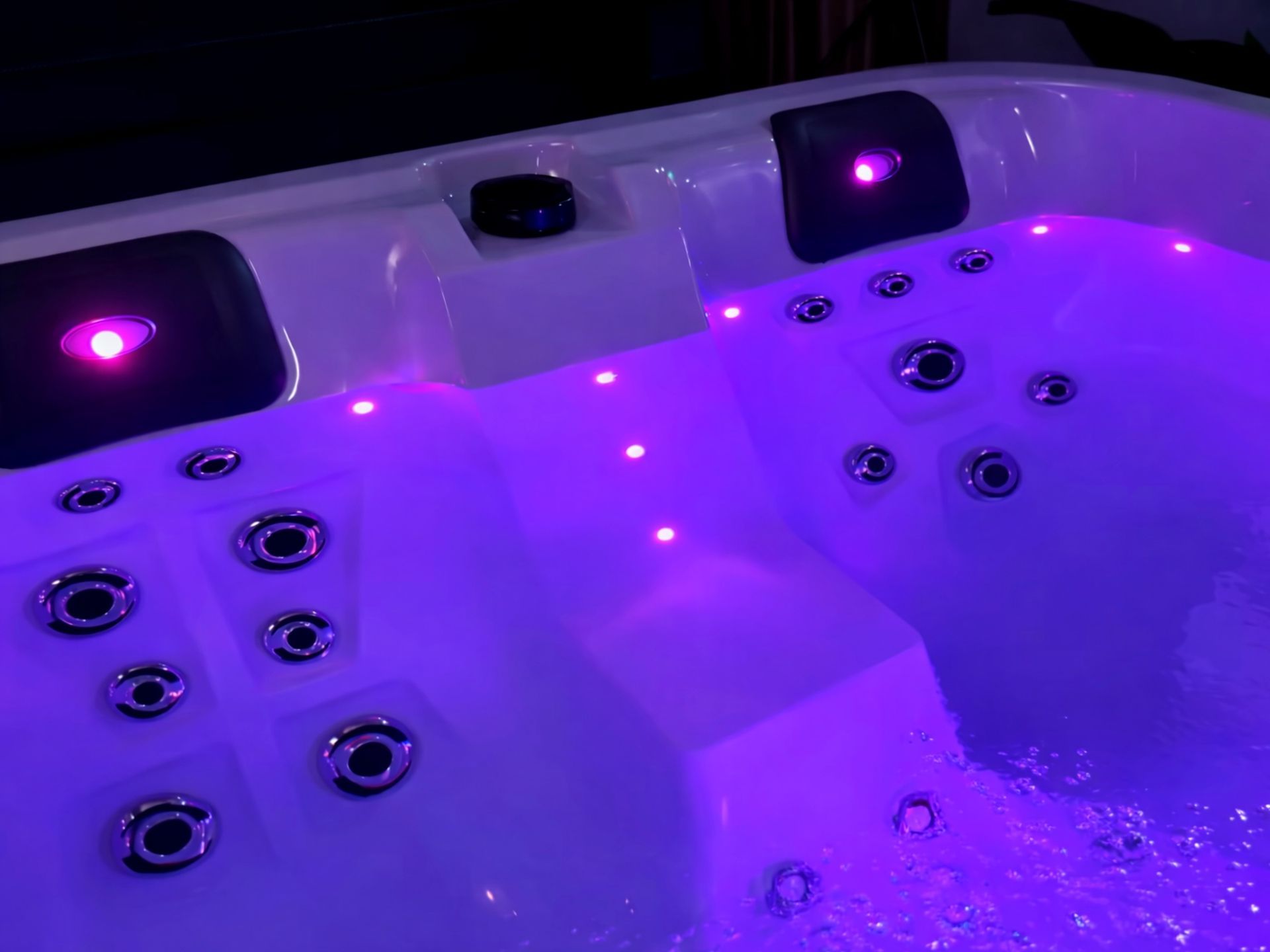 ระบบแสงไฟ LED ใต้น้ำภายในอ่างน้ำร้อน ให้แสงสีม่วงสร้างบรรยากาศผ่อนคลายแบบสปา พร้อมหัวเจ็ทนวดรอบที่นั่ง รองรับการใช้งานช่วงกลางคืนและเพิ่มความหรูหราให้พื้นที่พักผ่อน
