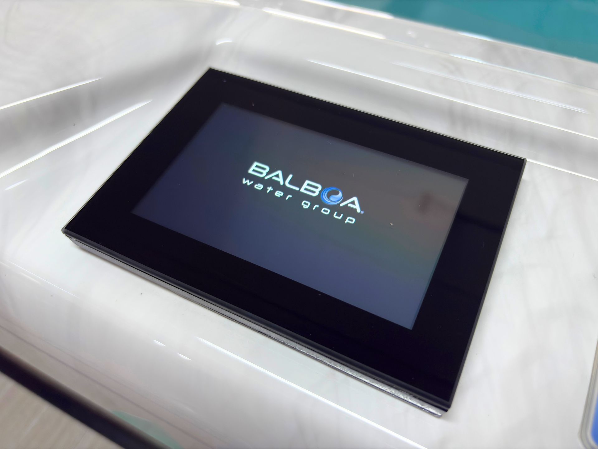 Hot tub touchscreen displaying the Balboa Water Group logo during system startup.