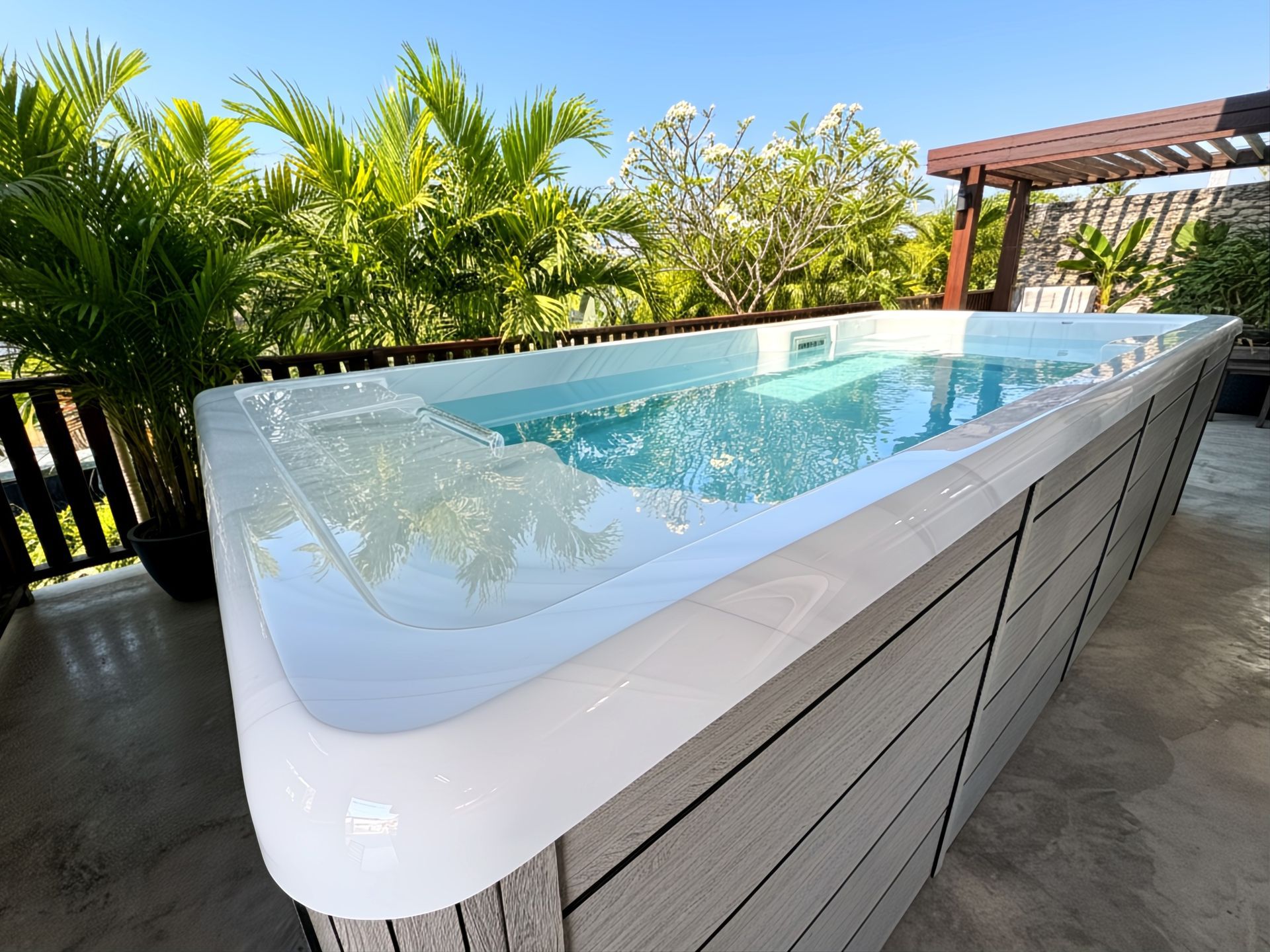 Swim Spa Ultimate 16 installed on an outdoor deck, featuring a compact swimming pool design with a galvanized steel frame