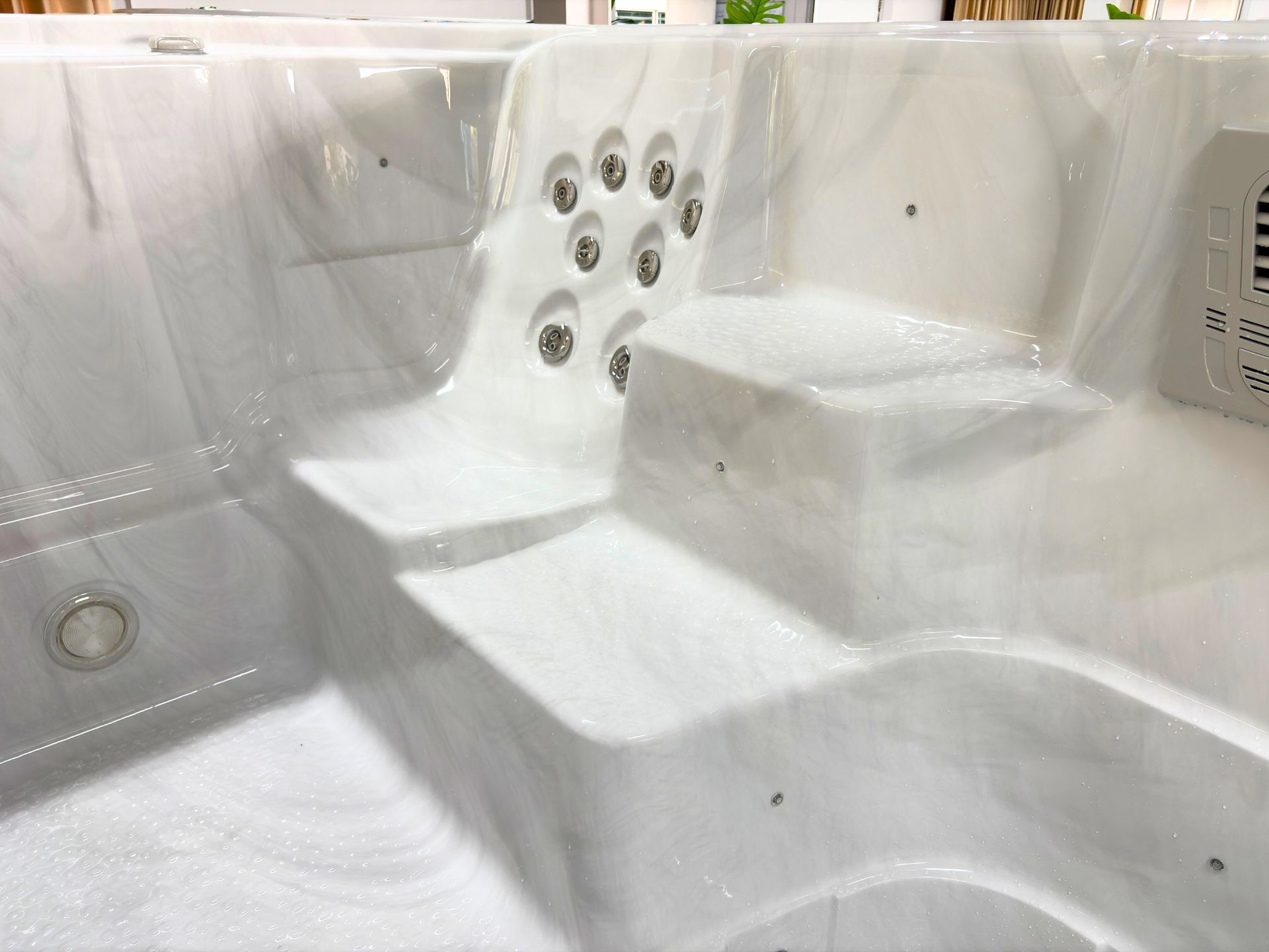 Step entry and molded seating area inside Swim Spa Ultimate 16 with anti-slip acrylic surface