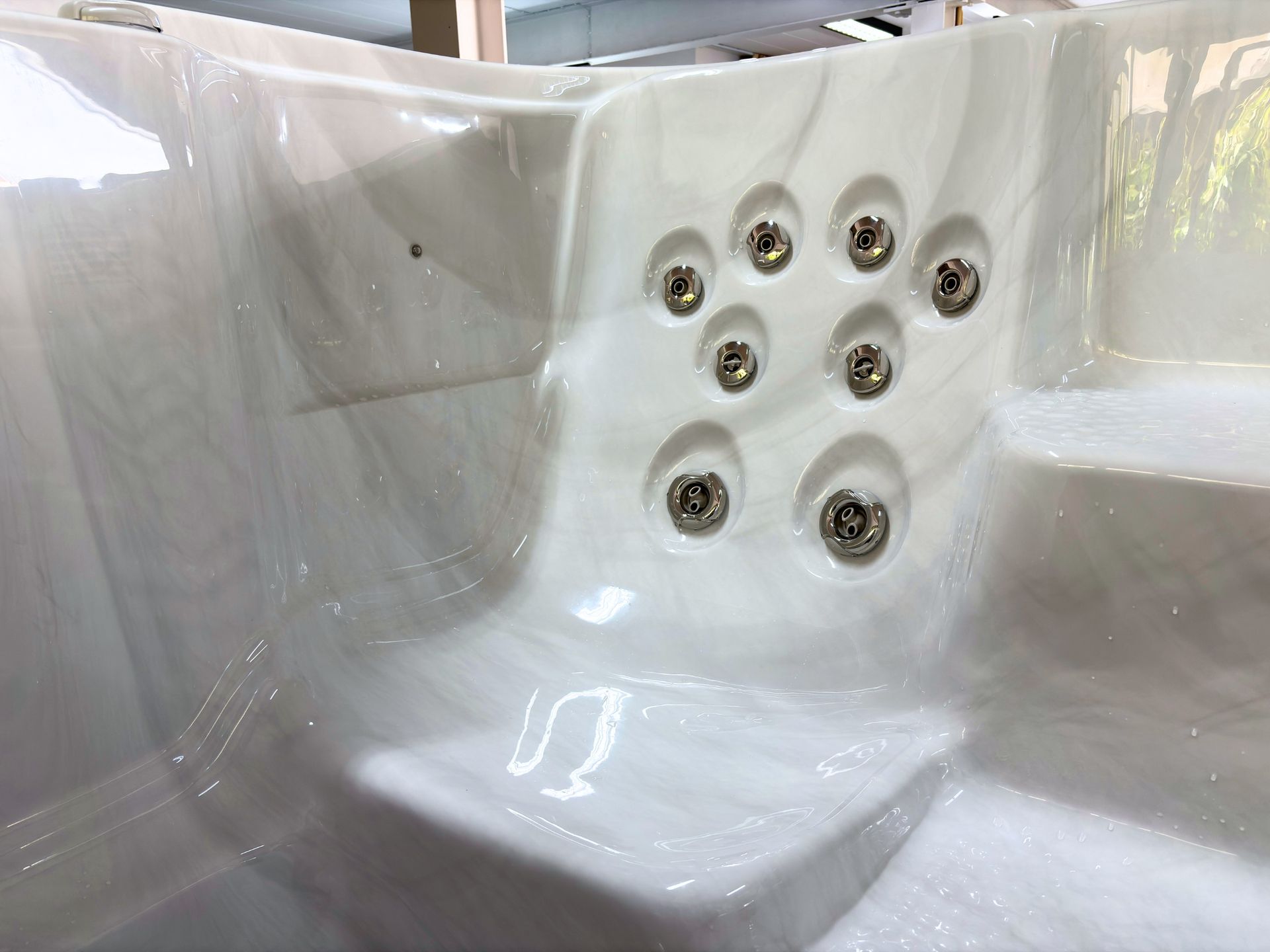 Hydro massage seating area with multiple stainless steel jets inside Swim Spa Ultimate 16