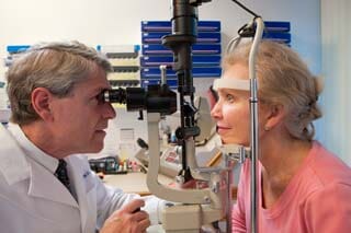 Ophthalmologist examining a woman's eyes with a slit lamp - Eye Care in Rocky Mount, NC