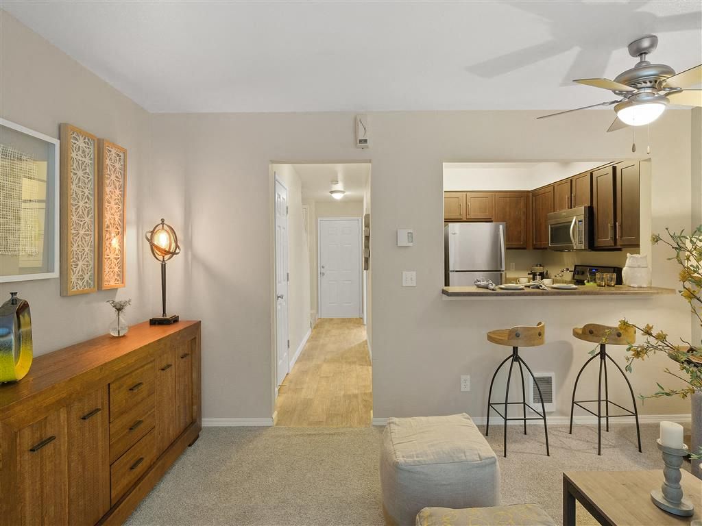 Open-plan living area with a kitchen island and bar seating.