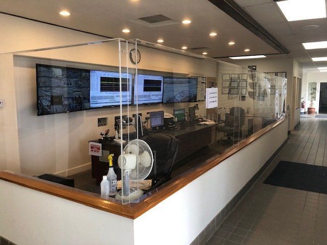 A nurse 's station with a glass wall and a fan.