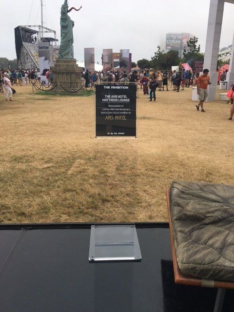 A statue of liberty is in the middle of a field