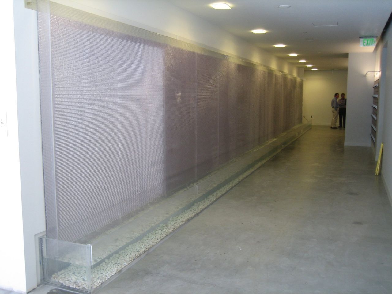 A long hallway with a wall that has a pattern on it