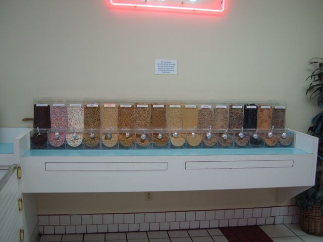 A row of containers filled with different types of grains