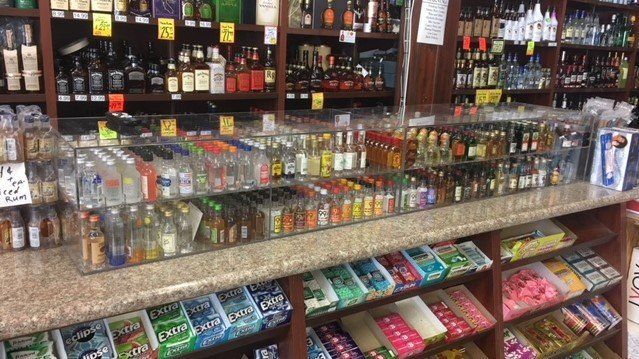 A liquor store filled with lots of bottles and candy