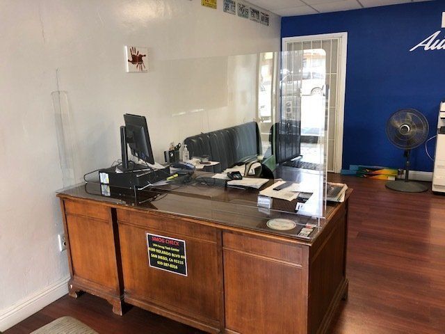 A wooden desk with a computer on it in a room.