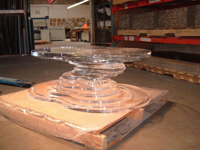 A clear glass table is sitting on a wooden pallet