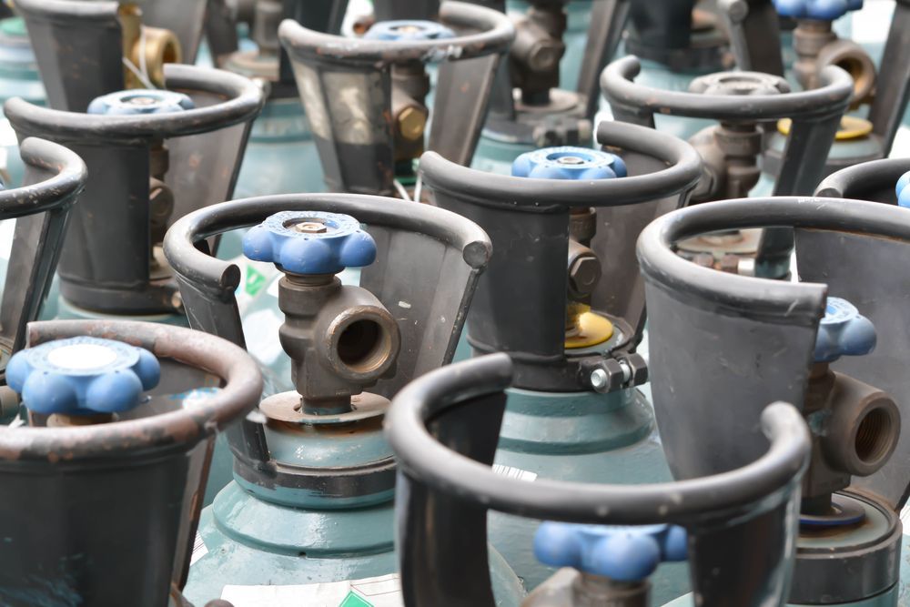 Close-up View of a Collection of Blue-handled Gas Cylinders — Kuranda Gas & Supplies In Koah, QLD