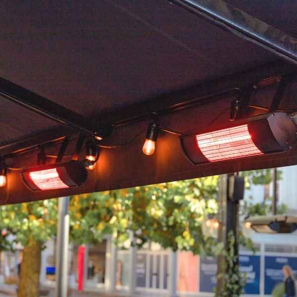 Outdoor Patio Heaters Mounted Under a Black Awning, Emitting Red Glow — Kuranda Gas & Supplies In Koah, QLD