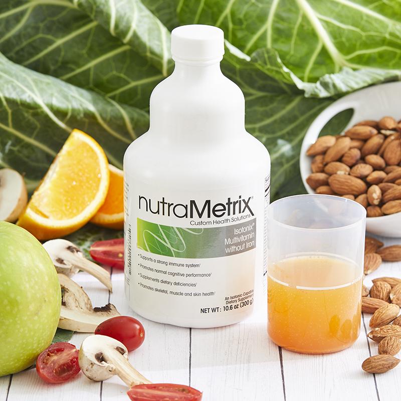 A bottle of nutrametrix is surrounded by fruits and vegetables