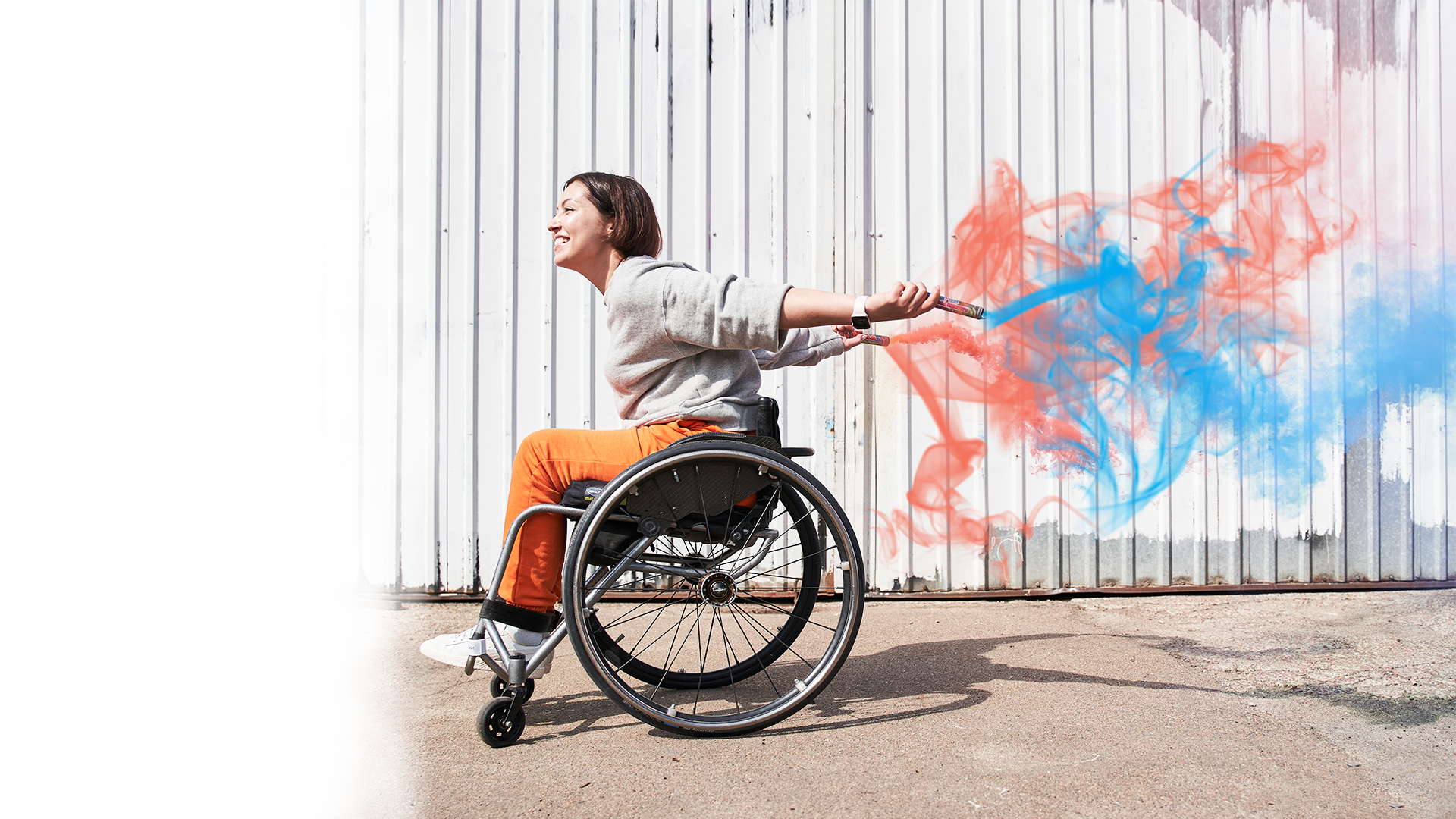 photo of a woman in a wheelchair with flares looking happy