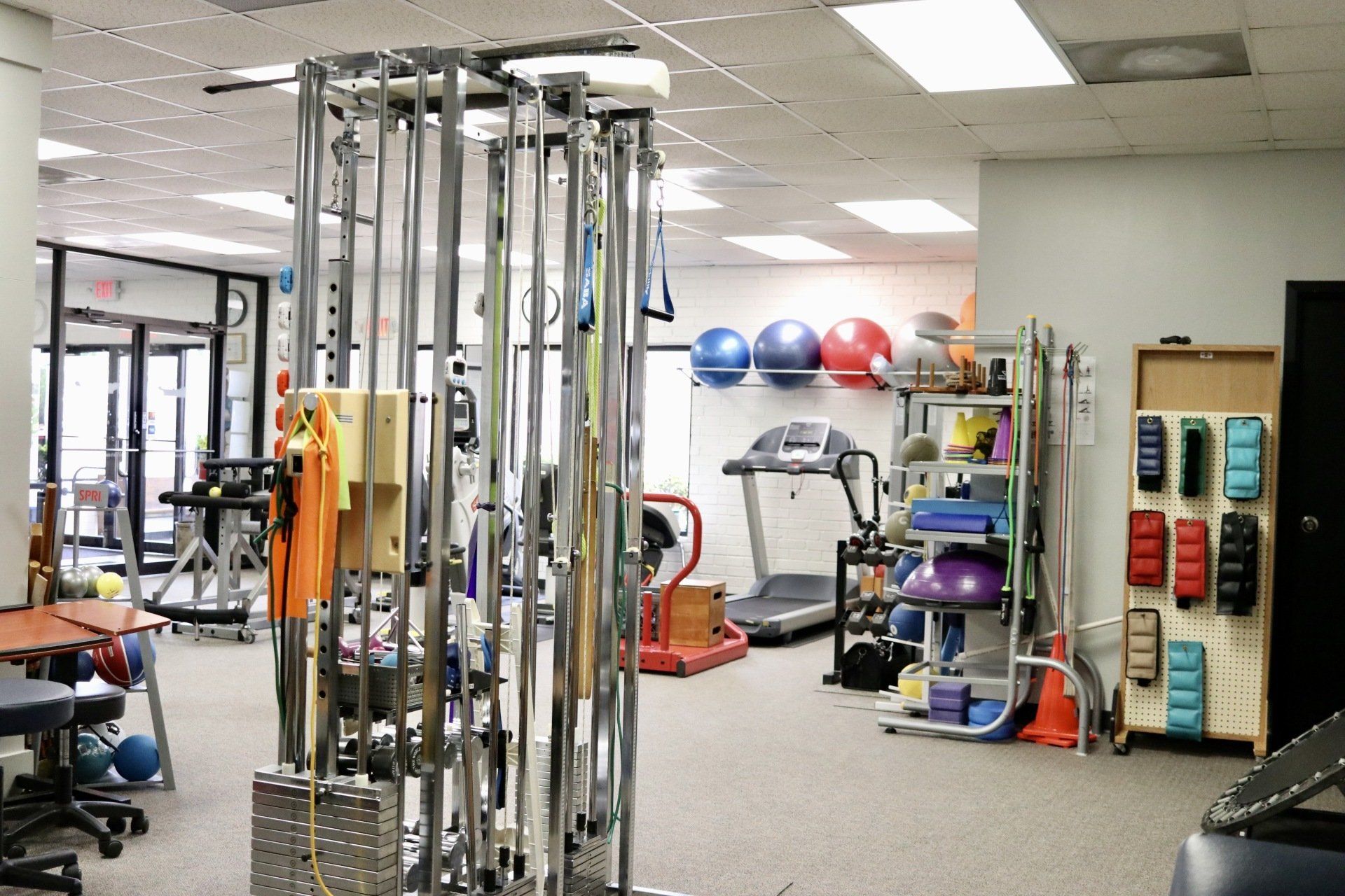 a gym filled with exercise equipment and balls