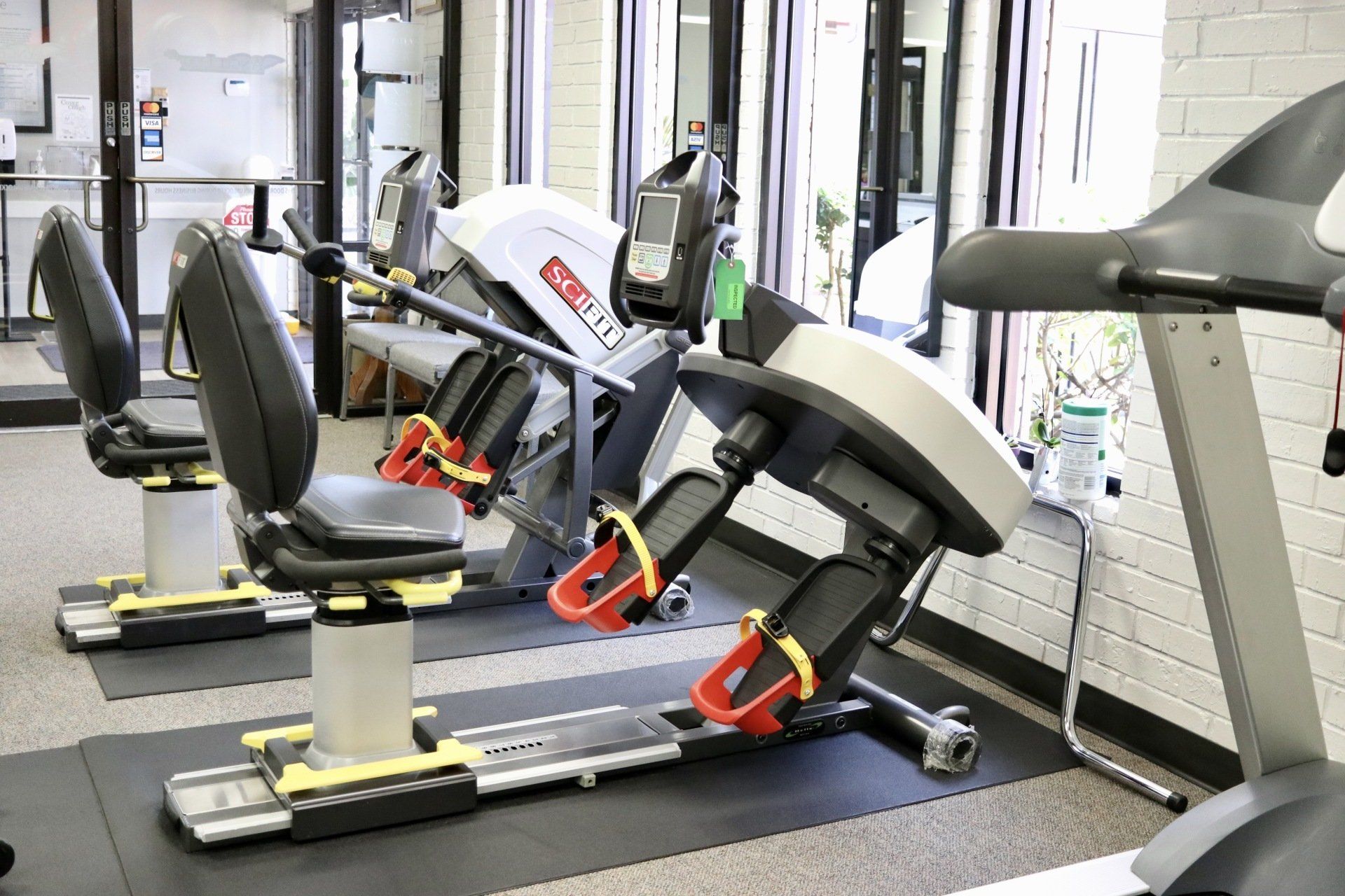 a gym with a treadmill and exercise bikes