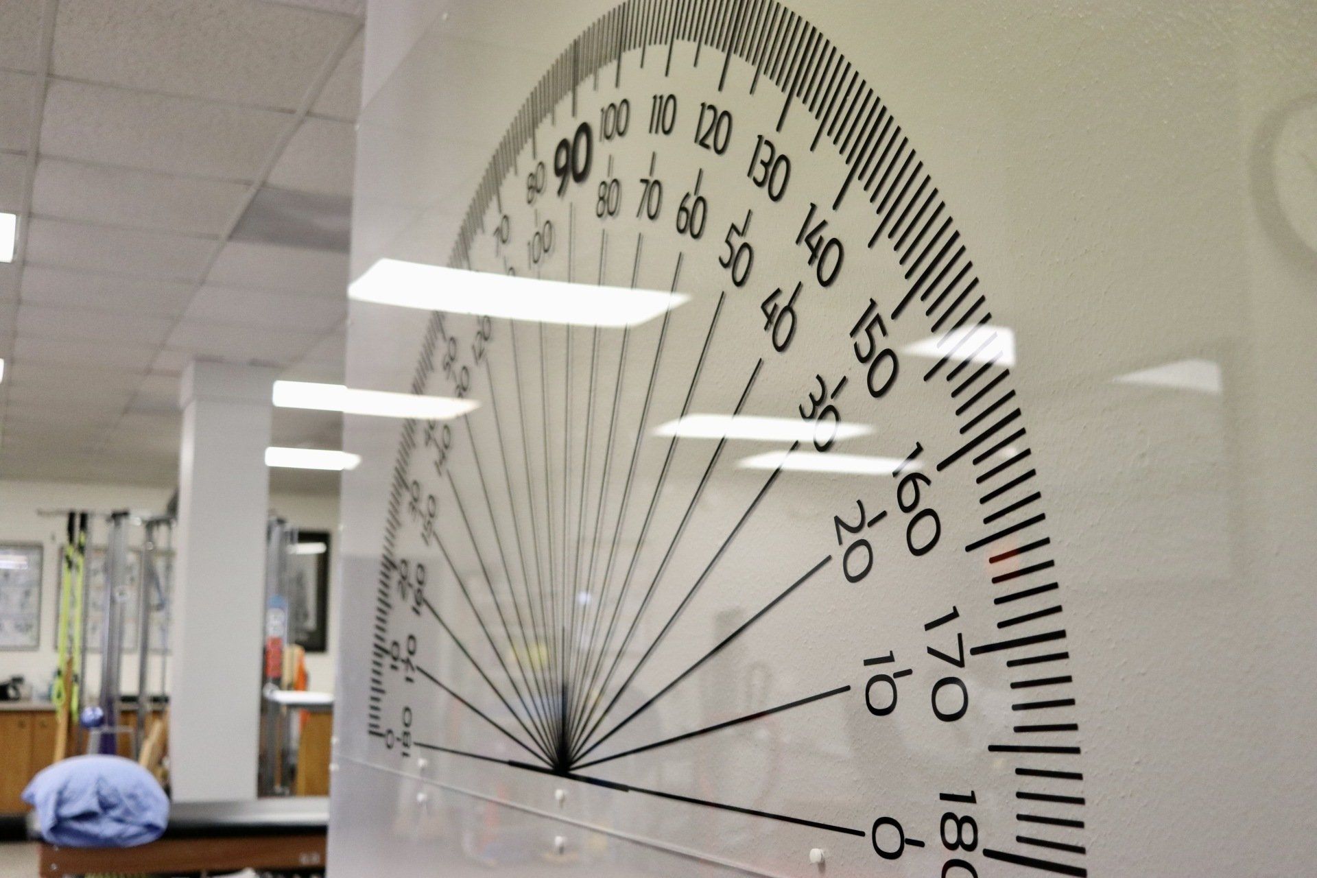 a large ruler is hanging on a wall and shows the degrees in degrees