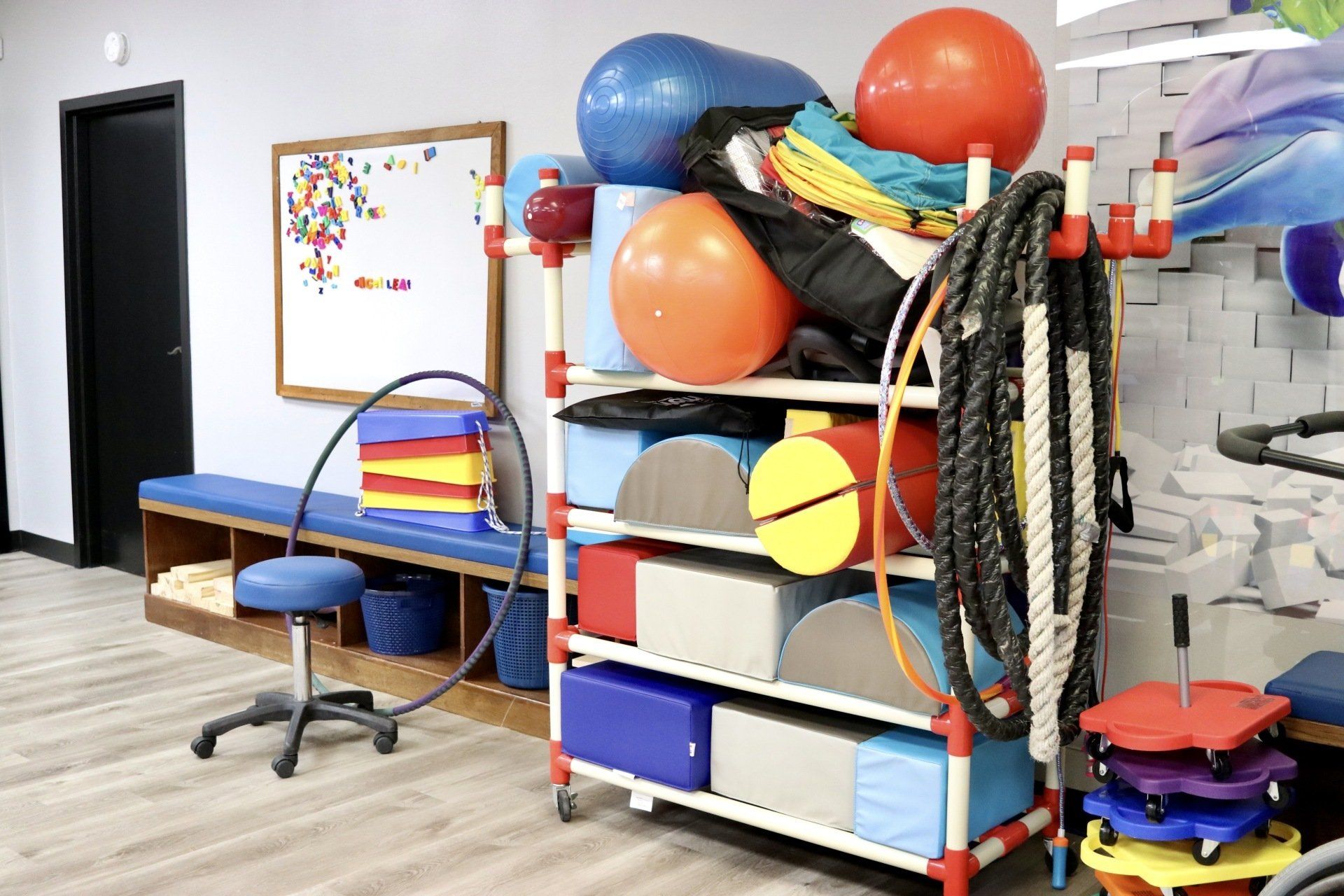a room filled with lots of exercise equipment and a stool .