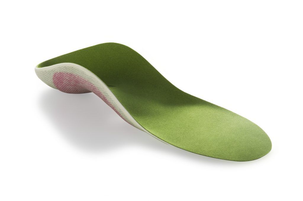 a green and pink shoe insole on a white background