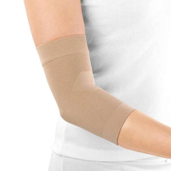 a woman is wearing a tan elbow brace on her arm .