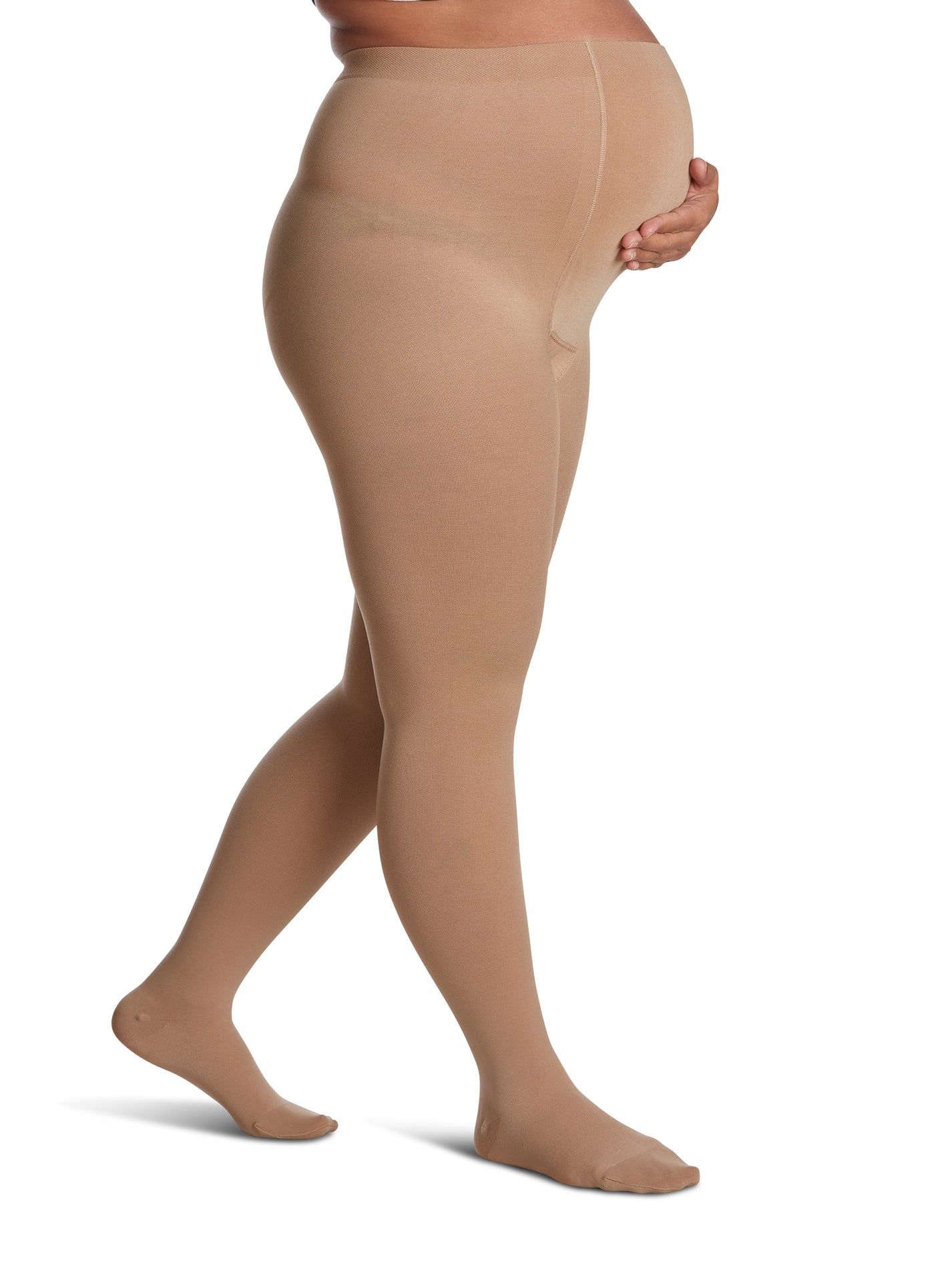 a pregnant woman wearing a pair of tan tights