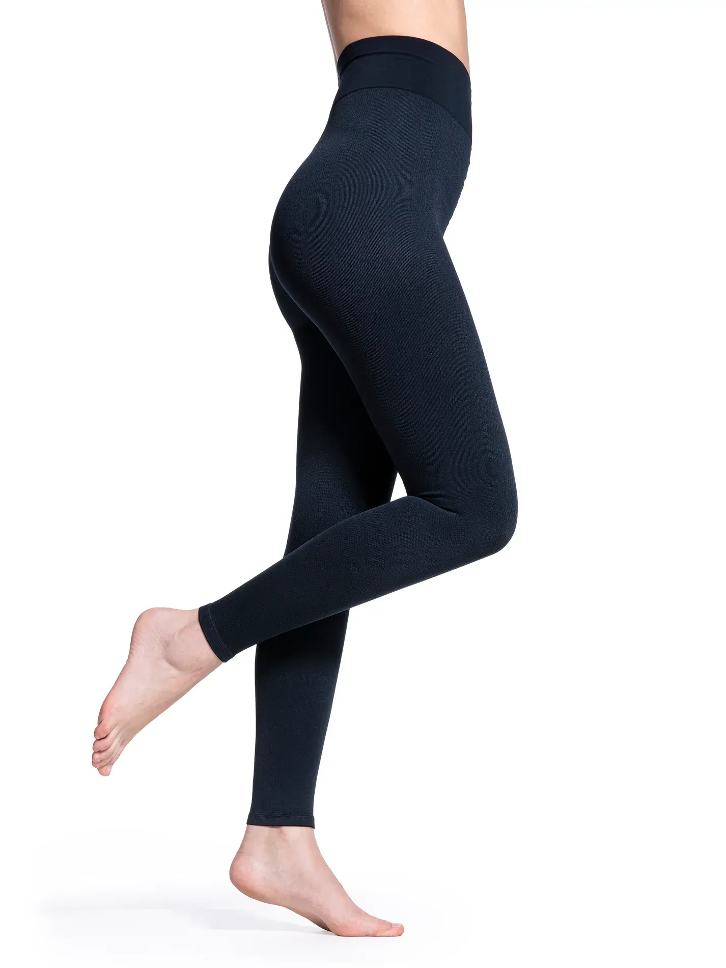 a woman is wearing a pair of black leggings .