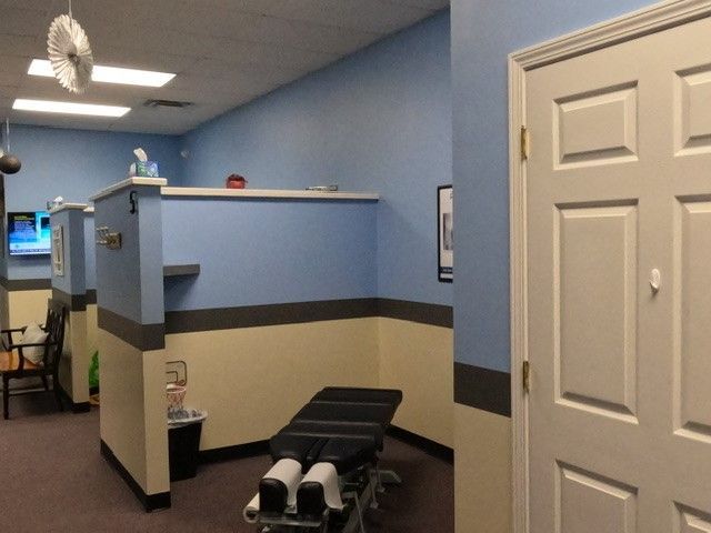 A room with a table in it and a clock on the wall