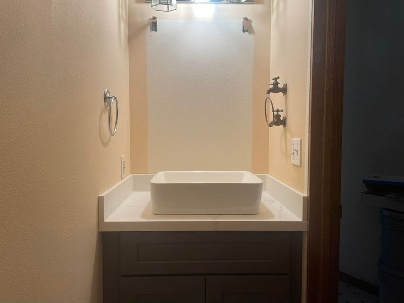 A bathroom with a sink and a towel rack.