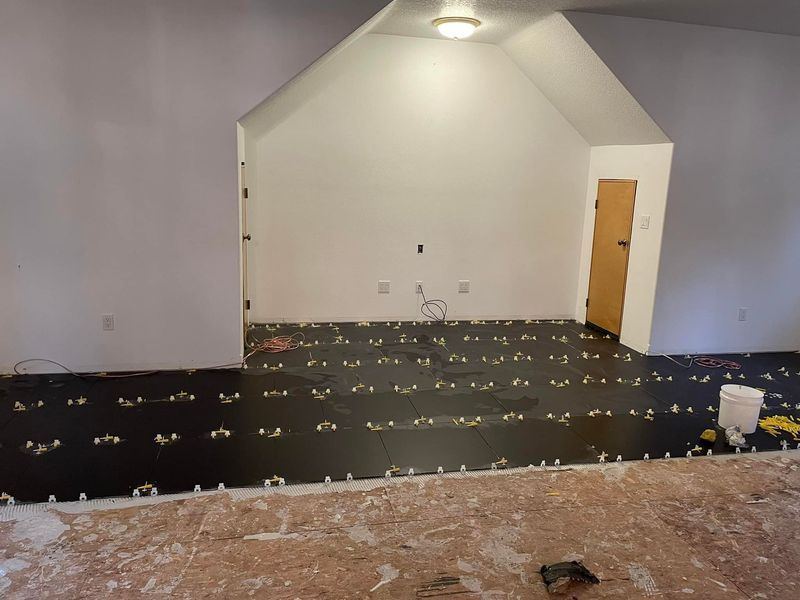 A room with a triangle shaped ceiling and a door